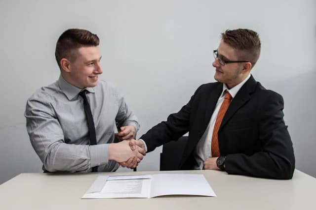 Business partners shaking hands after a successful logistics agreement
