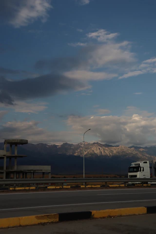 Freight truck travelling on schedule along a regional highway corridor