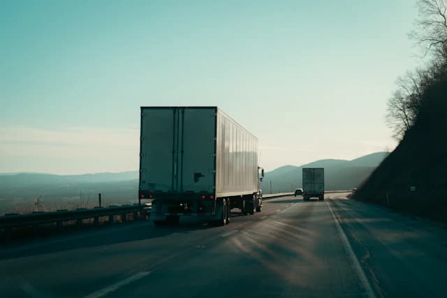 Multiple freight trucks operating across a connected regional highway network